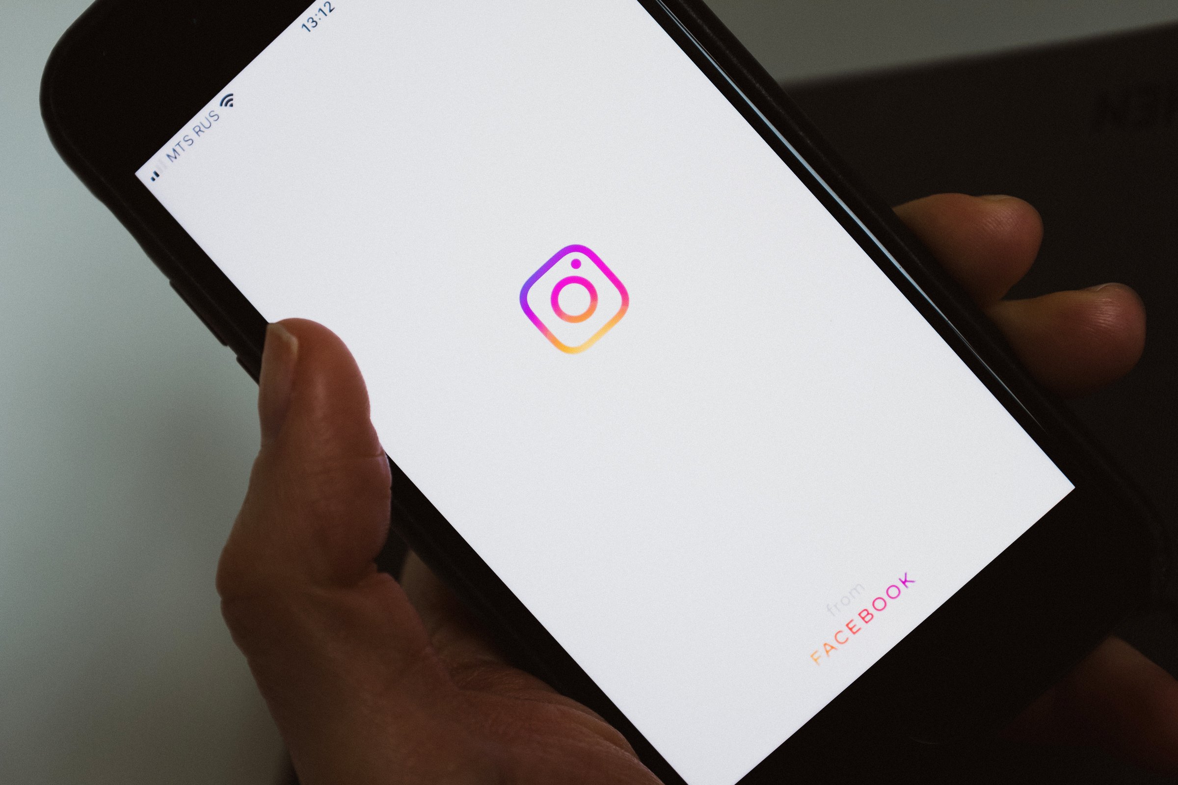 Crop anonymous person using social media application on smartphone